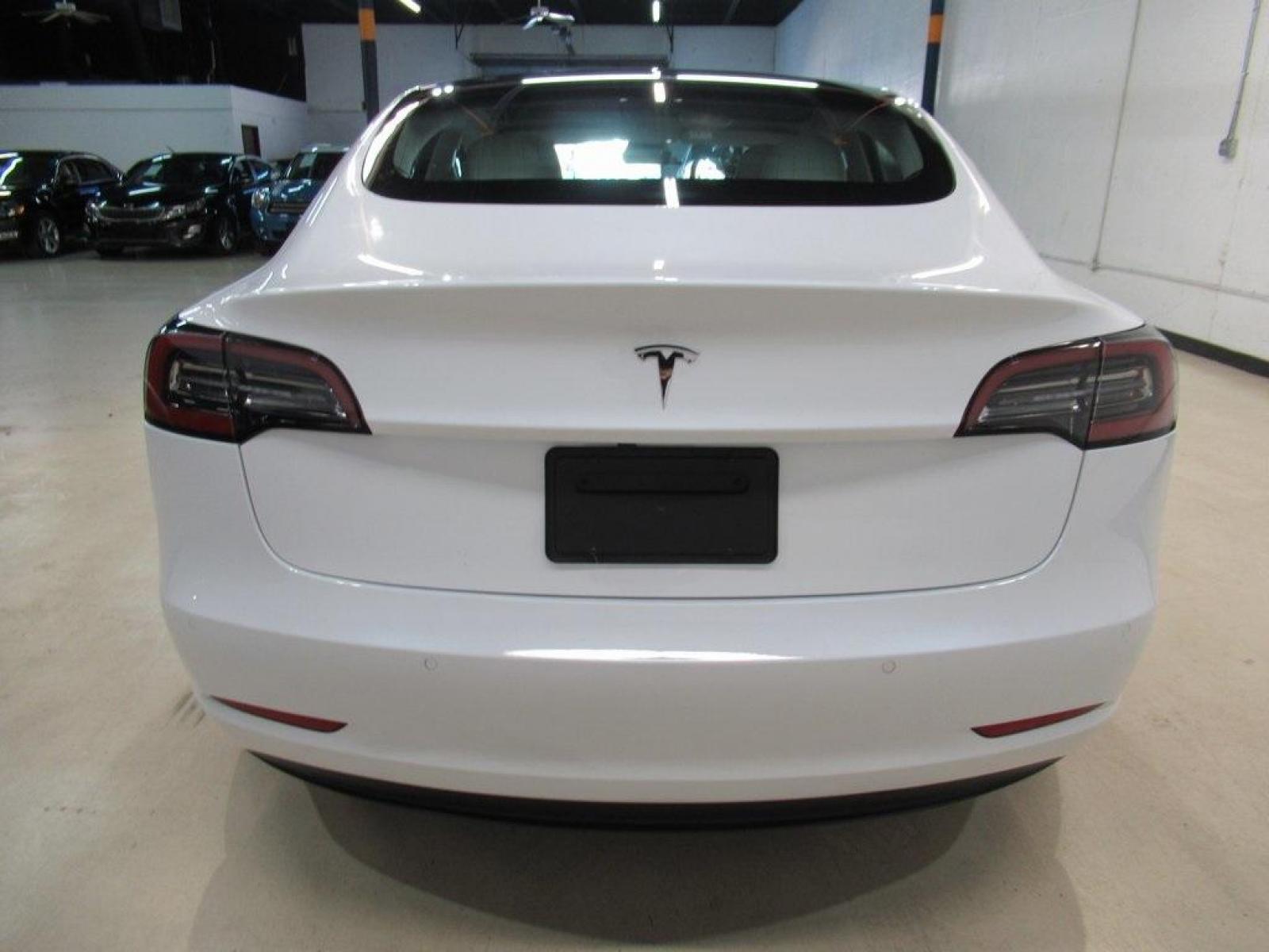 2019 Pearl White Multi-Coat /White/Black Tesla Model 3 Mid Range (5YJ3E1EA3KF) with an 10-Cylinder Electric ZEV engine, Automatic transmission, located at 15300 Midway Rd., Addison, 75001, (972) 702-0011, 32.958321, -96.838074 - HOME OF THE NO HAGGLE PRICE - WHOLESALE PRICES TO THE PUBLIC!! Model 3 Mid Range, 4D Sedan, 10-Cylinder Electric ZEV, 1-Speed Automatic, RWD, White, White/Black w/Premium Seat Trim. Priced below KBB Fair Purchase Price! Odometer is 6764 miles below market average!<br><br>White 2019 Tesla Model 3 Mid - Photo #7